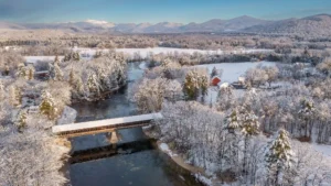 Snow-covered Mount Washington and covered bridge viewed from North Conway